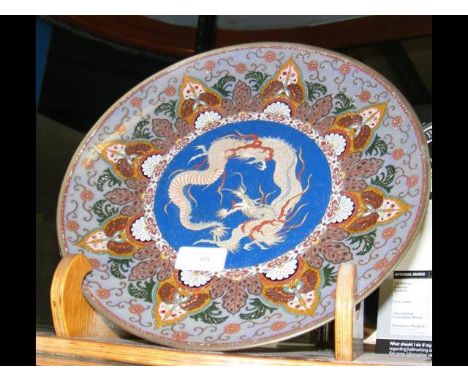 A 30cm diameter cloisonne shallow dish with dragons to the centre CONDITION REPORTCondition is fair. Some enamel loss to the 