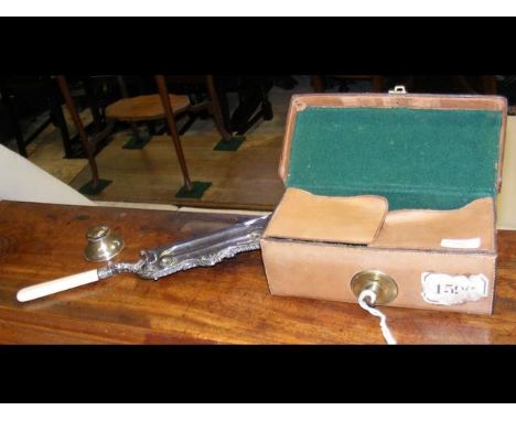 A leather box containing silver plated ware, together with a small silver inkwell capstan