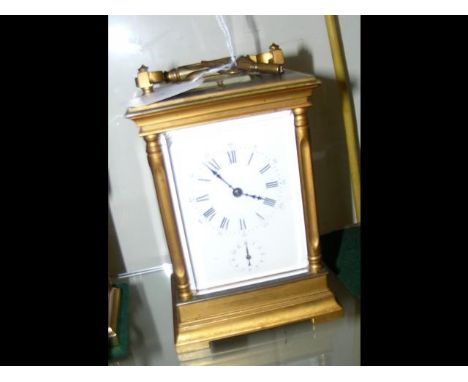 A brass cased repeater carriage clock with enamel dial - 15cm high CONDITION REPORTClock is in ticking order with no signs of
