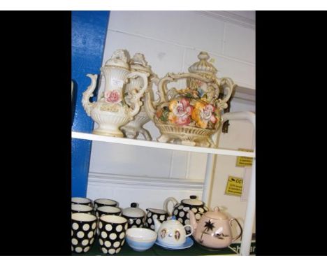 Two shelves of collectable ceramic ware, tea pots etc
