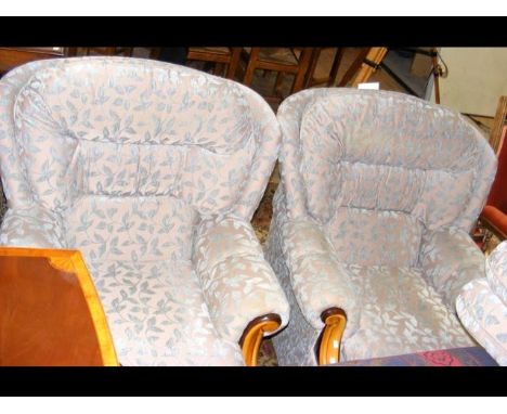 A three piece lounge suite upholstered in light blue floral material