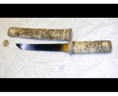 An antique Japanese dagger with 21cm long blade, having carved ivory handle and scabbard depicting domestic scenes