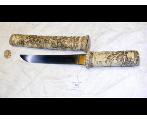 An antique Japanese dagger with 21cm long blade, having carved ivory handle and scabbard depicting domestic scenes