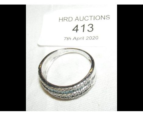 A white gold and diamond set half eternity ring with pale blue stones 