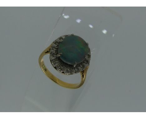 An oval opal double and diamond Ring, mounted in 18ct yellow gold, Size N.