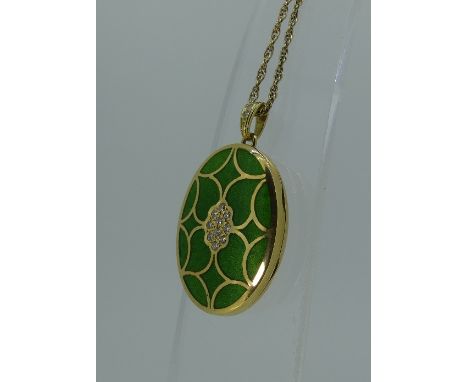 An attractive 18ct yellow gold oval Hinged Locket, the front with a vivid green guilloche enamel within gold wirework section