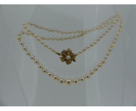 A graduated cultured pearl Necklace, with a 14k gold snap, set single cultured pearl.