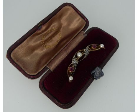 A crescent moon shaped Bar Brooch, formed of swirling bars, the centres set with a central cultured pearl and two rubies, dia