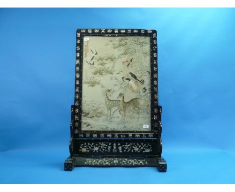 An Oriental hardwood Table Screen, of rectangular form with an embroidered tapestry centre depicting Chinese water deer, monk