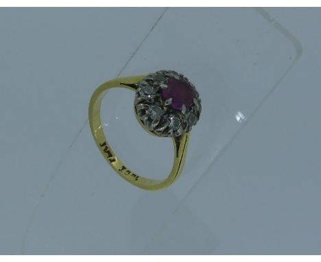 A pale ruby and diamond Cluster Ring, mounted in 18ct yellow gold, Size M.