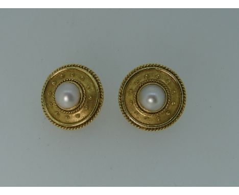 A pair of 18ct yellow gold 'Target' Earrings, the centres set half cultured pearl, pillar and clip fitting, marked 750, 1in (