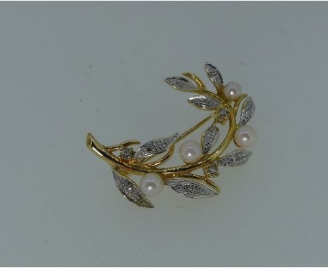 A small Brooch, in the form of a branch set in white and yellow gold some white gold leaves set with diamonds and with four s