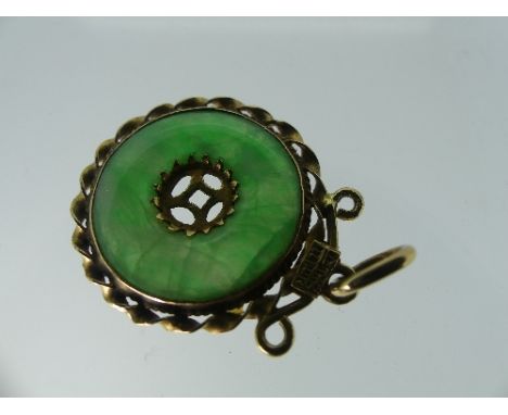 An 19ct yellow gold mounted tubular jade Bar Brooch, together with a yellow gold mounted circular jade disc pendant (2)