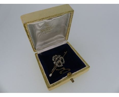 A pretty Bar Brooch, the centre set with a double heart motif with ties bow above, all set with small diamonds, on a yellow m