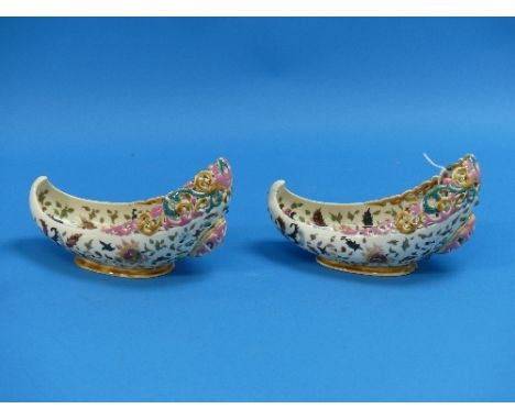 A pair of Zsolnay Pecs majolica reticulated slipper-shaped Vases, circa 1880's, of pierced oval form decorated in the Persian