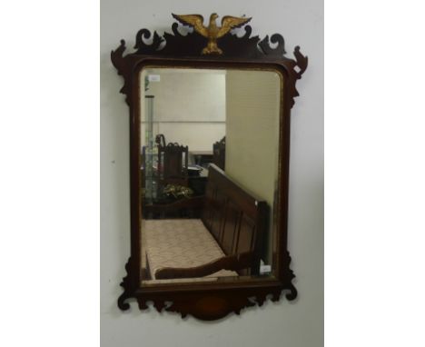 A 19thC walnut framed Mirror, the rectangular mirror plate with bevelled edge, a moulded surround and shaped frame with a scr