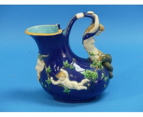 A Minton majolica mermaid and cherub Wine Pitcher, the blue ground jug with figural mermaid handle, a satyr mask below the sp