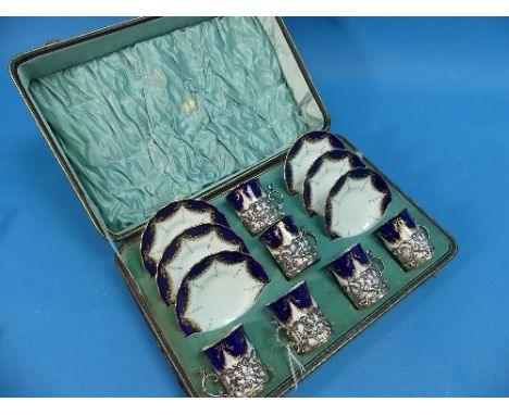 A cased set of six Edwardian silver Coffee Can Holders, by Jay, Richard Attenborough &amp; Co., hallmarked Chester, 1904, wit