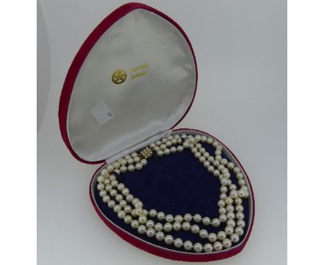 Two Cultured Pearl Necklaces, one three row with a square 14k yellow gold snap, the front with three rows of three small cult