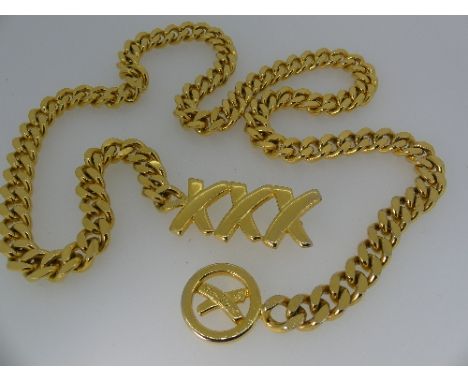 Paloma Picasso; A gilt metal curb link chain Belt, with trademark triple kiss fastening and signed 'By Paloma Picasso', circa