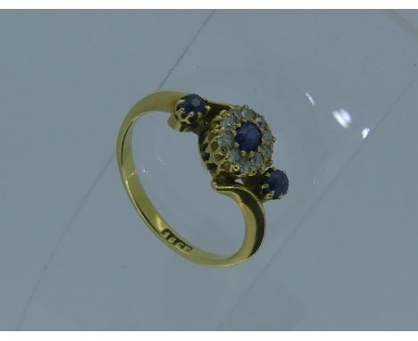 A sapphire and diamond Cluster Ring, the central pale sapphire with diamonds surround, with two small sapphires either side, 