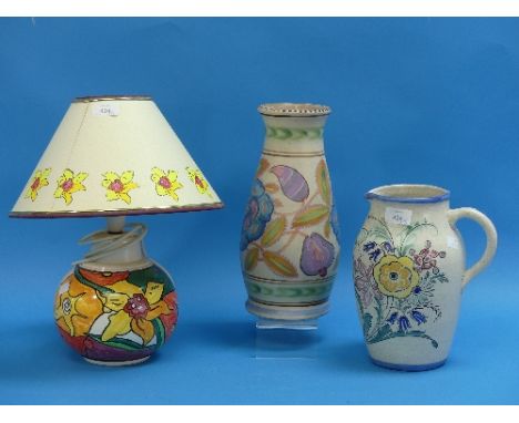 Honiton Pottery;  a tall vase, together with a large jug and a daffodil design table lamp and shade (3)