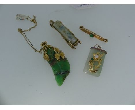 A small collection of Oriental Jewellery, including a small 18ct yellow gold bar brooch, set cabochon jade centre, an attract