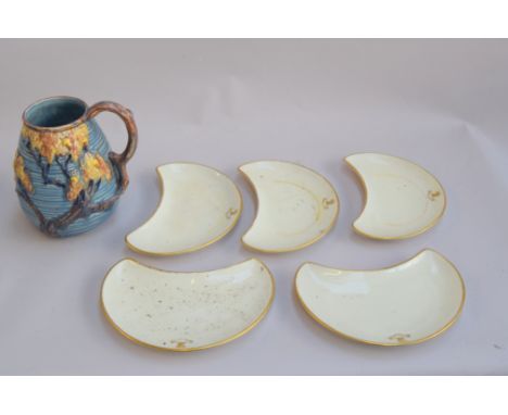 A Carltonware jug with a pattern of trees and acorns together with 5 kidney shaped cream Royal Worcester salad plates from La