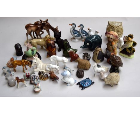 A selection of ceramic animal figurines, to include deer, an owl and more