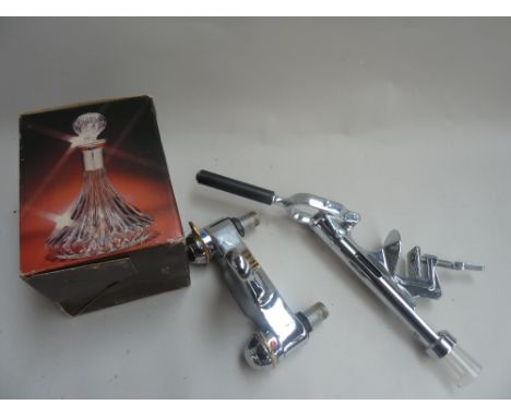 A mixed lot to include a glass decanter a bar mounted corkskrew and a bath fitting (3)