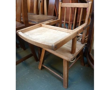 A vintage pine childrens chair with removeable tray