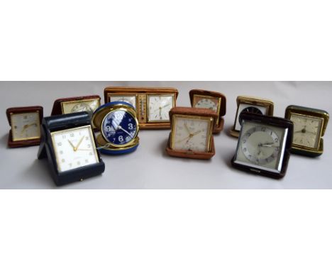 A quantity of travel clocks mostly in leather cases to include Looping, Europa, Junghans BiVox, Luxor, Kienzle and Estyma tra