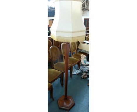 A floor standing lamp with hexagonal base and tapered column