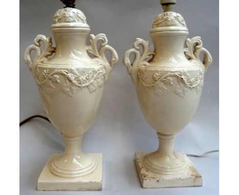 A pair of ceramic lamps in the shape of urns