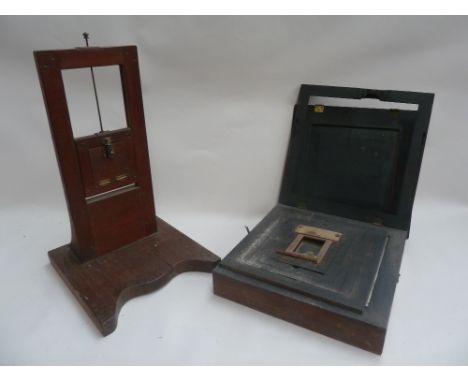 A vintage film photography editing block together with a vintage enlarger