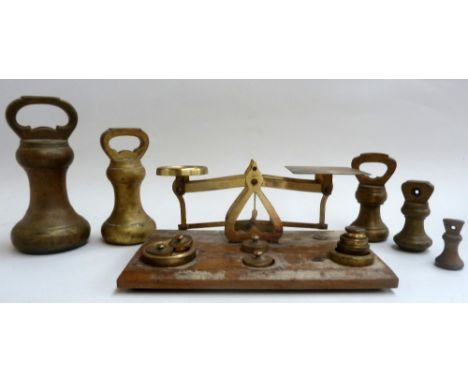 A set of jewellers scales with weights together with other larger weights