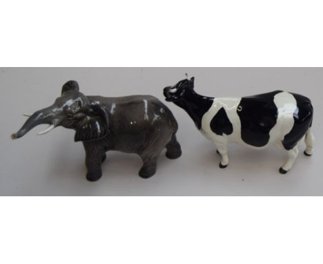 A large Beswick elephant, with trunk in salute, dark grey gloss, together with a Beswick gloss Friesian cow CH "Claybury Leeg
