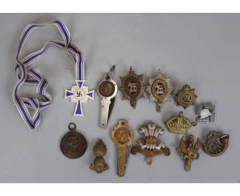 Collection of military items to include hat badges etc 