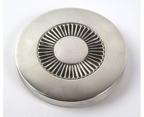 A Georg Jensen sterling silver powder compact 
Of circular form, with reeded central decoration, impressed marks and numbered