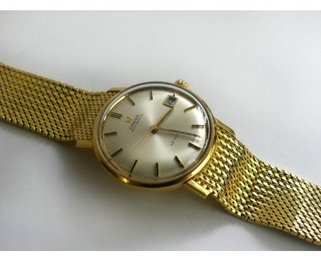 An 18ct gold Omega Automatic De Ville watchThe silvered dial with Roman numerals and date aperture, total weight 87g, complet