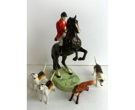 A Beswick ceramic hunting set
To include huntsman on rearing horse, height 24cm, three hounds and a fox CONDITION REPORT: Fox