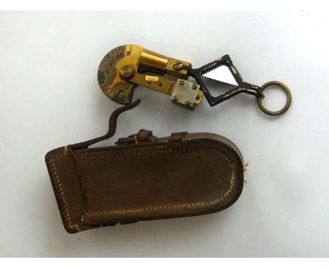 A cased folding brass clinometer Marked Palmer and bears military arrow mark 