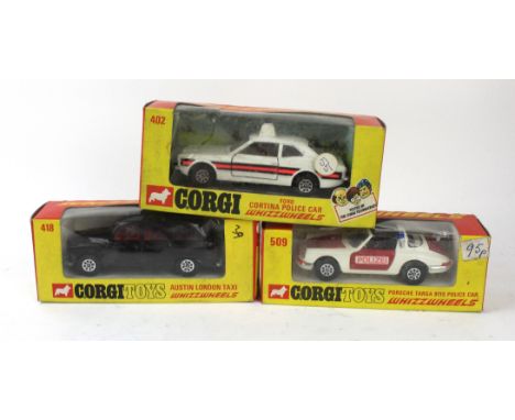 Three boxed Corgi Whizz WheelsComprising no. 402 Ford Cortina police car in white, 418 Austin London Taxi in black and 509 Po