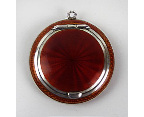 A fine sterling silver and guilloche enamel powder compact
Of small circular form, with deep orange enamelled decoration, imp