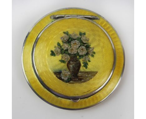 A rare large sized guilloche enamel continental powder compact
Of circular form, with yellow enamelled decoration with centra