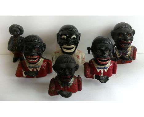 A collection of five various cast metal Jolly money boxes Of varying designs together with a further ceramic example, largest