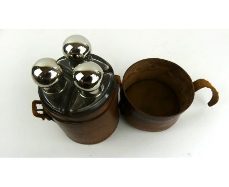 A leather cased three bottle hunting flask, early 20th CenturyThe circular leather case with inset bottles, leather cover, co
