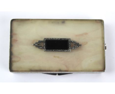 A George V Art Deco imported silver powder compact
Of rectangular form, with applied black panel surrounded by jeweled angled