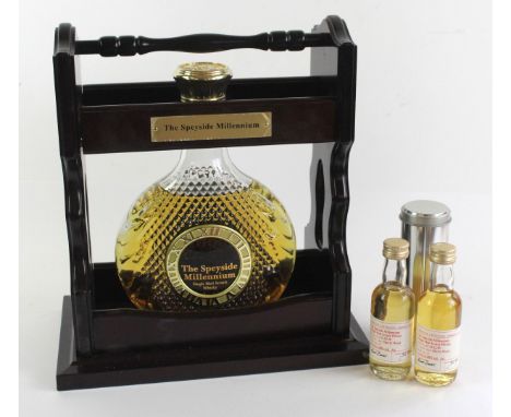 1 decanter Bottle in Tantalus (slightly damaged and missing key) 'The Speyside 'Millennium' Pure Malt Whisky (Distilled 12th 