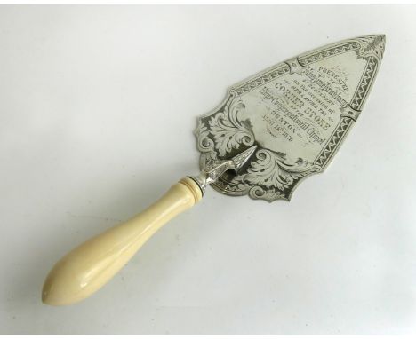 A late Victorian silver presentation trowel. The trowel with scrolling cartouche containing the inscription 'Presented to Mis